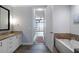 Bathroom featuring tub and granite vanity countertop leading to a bedroom with beautiful city view at 270 17Th Nw St # 2210, Atlanta, GA 30363