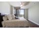 Bright bedroom with hardwood floors, ceiling fan, and access to a private balcony with city views at 270 17Th Nw St # 2210, Atlanta, GA 30363