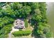 Aerial view of stunning estate with mature landscaping, lush green trees, and well maintained backyard at 5765 Riley Rd, Cumming, GA 30028