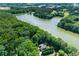 Beautiful lakefront home surrounded by lush, mature trees with endless waterfront views at 5765 Riley Rd, Cumming, GA 30028