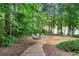 Backyard with a stone fire pit and seating, leading to a lake view at 5765 Riley Rd, Cumming, GA 30028