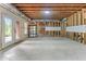 Unfinished basement featuring concrete floors, exposed ductwork, and a door to the backyard at 5765 Riley Rd, Cumming, GA 30028