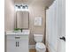 Bathroom featuring a vanity, toilet, framed mirror, and shower at 5765 Riley Rd, Cumming, GA 30028