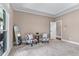 Spacious bedroom with two accent chairs, large windows, and neutral carpet at 5765 Riley Rd, Cumming, GA 30028