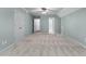 Expansive bonus room featuring neutral decor, plush carpeting, and ensuite bath and closet access at 5765 Riley Rd, Cumming, GA 30028