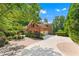 Elegant brick home featuring a circular driveway, attached garage, and professionally landscaped grounds at 5765 Riley Rd, Cumming, GA 30028