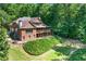 Brick home with a screened porch, landscaped lawn, and surrounding trees at 5765 Riley Rd, Cumming, GA 30028
