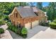 Brick home featuring an attached garage, professionally landscaped yard, and a private backyard at 5765 Riley Rd, Cumming, GA 30028