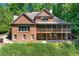 Brick home with screened porch and well-manicured front landscaping at 5765 Riley Rd, Cumming, GA 30028
