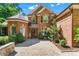 Charming brick home featuring a welcoming entrance with a paver walkway and manicured greenery at 5765 Riley Rd, Cumming, GA 30028