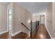Second floor hallway with wood floors and access to rooms at 5765 Riley Rd, Cumming, GA 30028