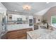 Modern kitchen with stainless steel appliances, granite countertops, and white cabinetry for ample storage at 5765 Riley Rd, Cumming, GA 30028