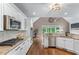 View of the modern kitchen with stainless appliances, granite counters, and an open layout at 5765 Riley Rd, Cumming, GA 30028