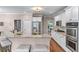 Open kitchen featuring granite countertops, stainless steel appliances, and barstool seating at 5765 Riley Rd, Cumming, GA 30028