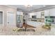 Bright kitchen featuring granite countertops, stainless appliances, and white cabinetry at 5765 Riley Rd, Cumming, GA 30028