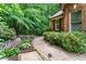 Beautifully landscaped walkway with lush greenery, brick accents, and a pathway leading to the house at 5765 Riley Rd, Cumming, GA 30028