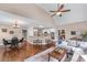 Open-concept living room featuring hardwood floors, a modern kitchen, and ample seating space at 5765 Riley Rd, Cumming, GA 30028