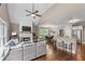 Open-concept living room featuring a fireplace, hardwood floors, and a vaulted ceiling at 5765 Riley Rd, Cumming, GA 30028