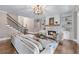 Elegant living room with a stone fireplace, built-in shelving, and plenty of natural light at 5765 Riley Rd, Cumming, GA 30028