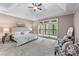 Spacious main bedroom boasting a tray ceiling, plush carpet, and a private balcony at 5765 Riley Rd, Cumming, GA 30028