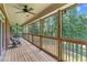 Relaxing screened porch with views of the large backyard at 5765 Riley Rd, Cumming, GA 30028