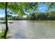Calm lake view surrounded by trees and sky, emphasizing the property's waterfront location at 5765 Riley Rd, Cumming, GA 30028