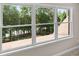 Bright window with beautiful views of lush green trees and glimpses of the roof top at 5765 Riley Rd, Cumming, GA 30028