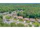 An aerial view shows the home nestled among mature trees and green lawns in a residential neighborhood at 935 Santa Anita Dr, Woodstock, GA 30189