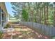 This backyard has a wooden privacy fence and a partially screened-in back porch at 935 Santa Anita Dr, Woodstock, GA 30189