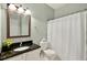 Bathroom with granite countertop vanity, large mirror, and shower with white curtain at 935 Santa Anita Dr, Woodstock, GA 30189