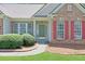 Close-up of the front door with neat landscaping and brick exterior at 935 Santa Anita Dr, Woodstock, GA 30189