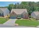Single-story home with manicured lawn, mature trees, and well-maintained landscaping at 935 Santa Anita Dr, Woodstock, GA 30189