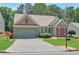 Lovely single-story house with attached garage, tidy lawn, and attractive landscaping details at 935 Santa Anita Dr, Woodstock, GA 30189
