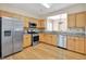 Bright eat-in kitchen features stainless steel appliances, granite countertops, and light wood cabinetry at 935 Santa Anita Dr, Woodstock, GA 30189