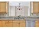 Close-up on a granite countertop with light wood cabinets and stainless steel appliances at 935 Santa Anita Dr, Woodstock, GA 30189