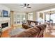 Inviting living room with a fireplace, natural light, and an adjoining dining area at 935 Santa Anita Dr, Woodstock, GA 30189