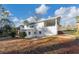 Backyard of a two-story white house with a covered porch and mature trees at 2480 Miriam Ln, Decatur, GA 30032