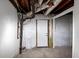 Unfinished basement showing exposed pipes and ductwork and utility area with door at 2480 Miriam Ln, Decatur, GA 30032