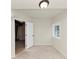 Basement room features an open door, a window providing natural light, and unfinished flooring at 2480 Miriam Ln, Decatur, GA 30032