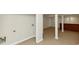 Spacious basement with tile flooring, support beams, brick bar, and a door to another room at 2480 Miriam Ln, Decatur, GA 30032