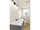 Bathroom with tiled floors and a modern vanity illuminated by an overhead light fixture at 2480 Miriam Ln, Decatur, GA 30032