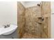 Tiled shower with tan patterned stone design with shower head and wall mounted handle at 2480 Miriam Ln, Decatur, GA 30032