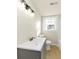 Bathroom featuring a modern vanity, sink, and toilet against a backdrop of natural light at 2480 Miriam Ln, Decatur, GA 30032