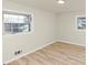 Cozy bedroom featuring hardwood flooring and two windows providing natural light at 2480 Miriam Ln, Decatur, GA 30032