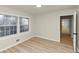 Bedroom featuring hardwood floors, natural light, and a glimpse of a stylish doorway at 2480 Miriam Ln, Decatur, GA 30032