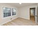 Bedroom features hardwood floors, light paint, and natural light from a double window at 2480 Miriam Ln, Decatur, GA 30032