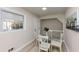 Bright eat-in kitchen area with hardwood flooring, natural light, and glass table with white chairs at 2480 Miriam Ln, Decatur, GA 30032