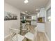 Bright eat-in kitchen features white cabinets, modern lighting, and a glass-top table at 2480 Miriam Ln, Decatur, GA 30032