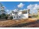 Back of a two-story home with a covered porch, small patio, and grassy yard at 2480 Miriam Ln, Decatur, GA 30032