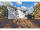 Back of a two-story home with a walkout basement and small green bushes at 2480 Miriam Ln, Decatur, GA 30032